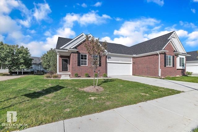 view of front of home with a garage, a shingled roof, concrete driveway, a front lawn, and brick siding