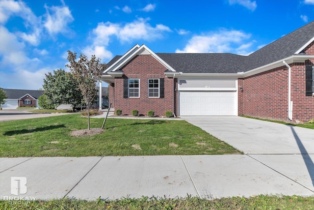 single story home featuring a garage, a shingled roof, concrete driveway, a front yard, and brick siding