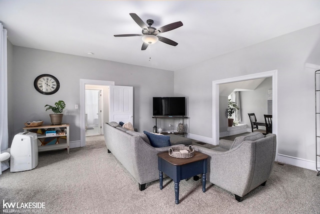 carpeted living room featuring ceiling fan