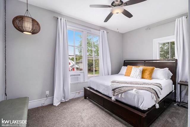 bedroom with multiple windows, ceiling fan, and carpet flooring