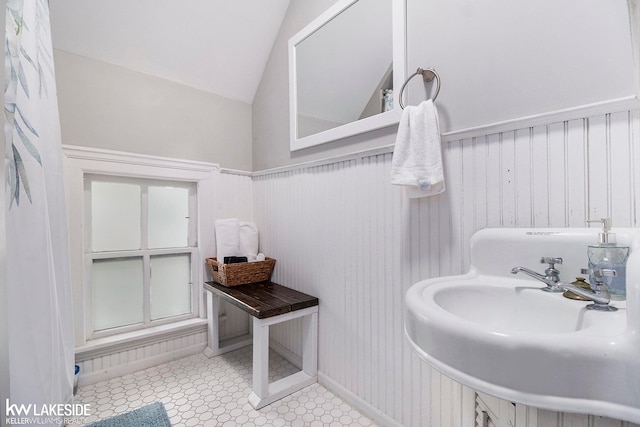 bathroom with lofted ceiling and sink