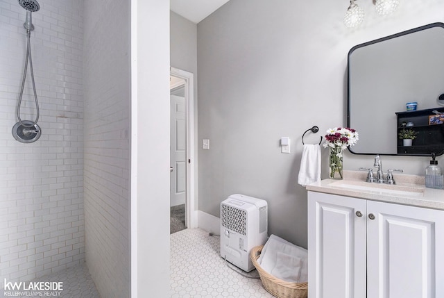 bathroom featuring vanity and tiled shower