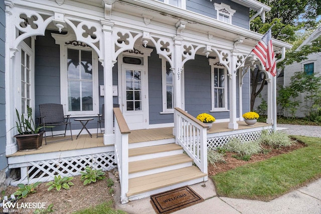 view of exterior entry featuring a porch