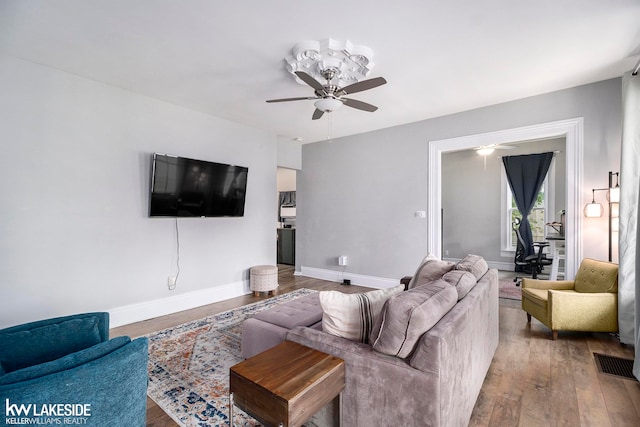 living room featuring ceiling fan and hardwood / wood-style floors