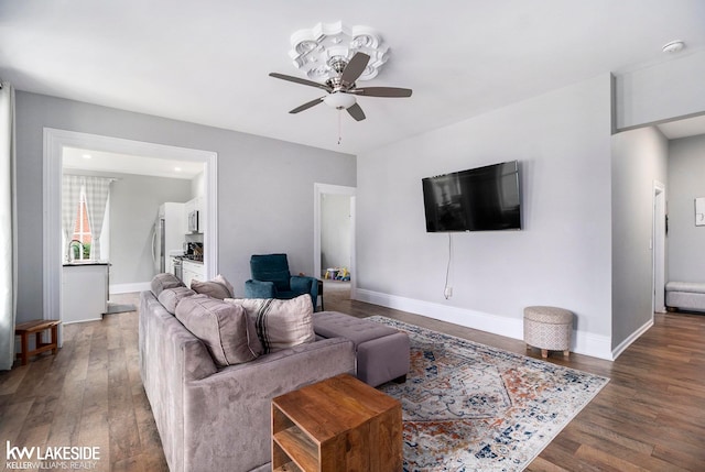 living room with ceiling fan and dark hardwood / wood-style floors