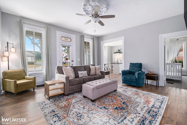 living room with dark hardwood / wood-style floors and ceiling fan