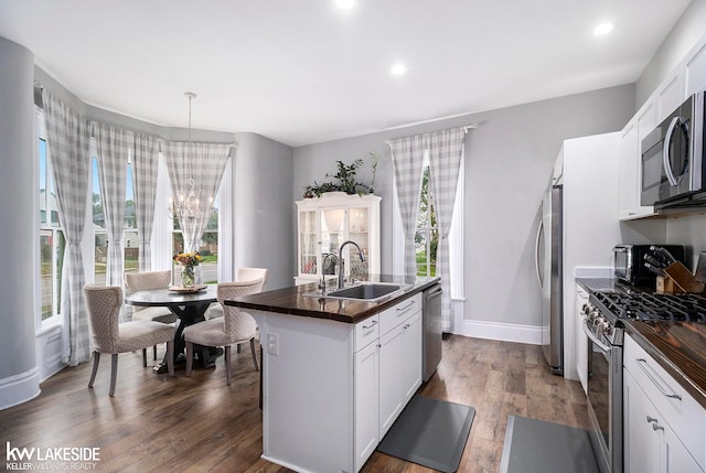 kitchen featuring an island with sink, white cabinets, appliances with stainless steel finishes, and sink