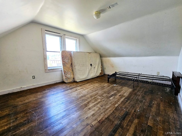 additional living space featuring vaulted ceiling and hardwood / wood-style flooring