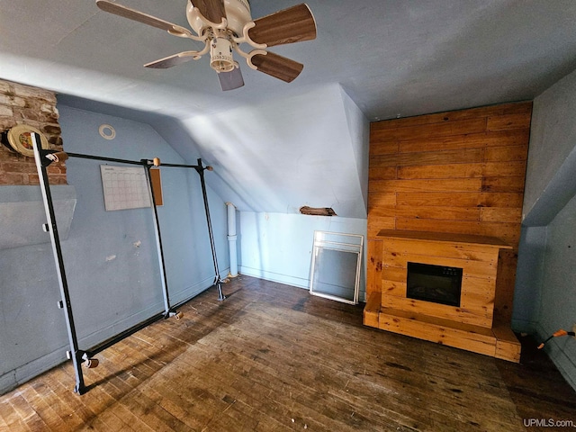 unfurnished living room with vaulted ceiling, ceiling fan, and dark hardwood / wood-style flooring