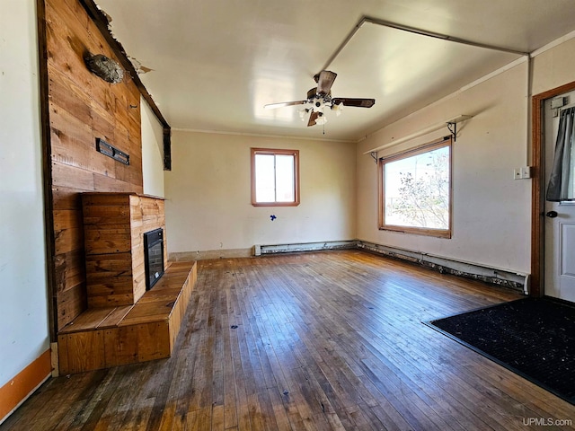 unfurnished living room with a baseboard radiator, ceiling fan, crown molding, and dark hardwood / wood-style flooring