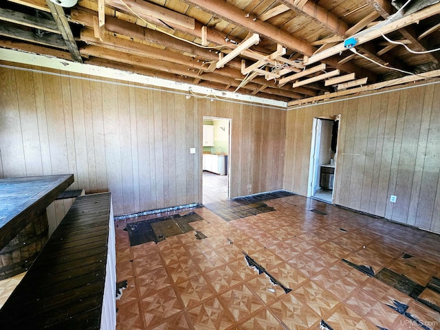 basement featuring wooden walls