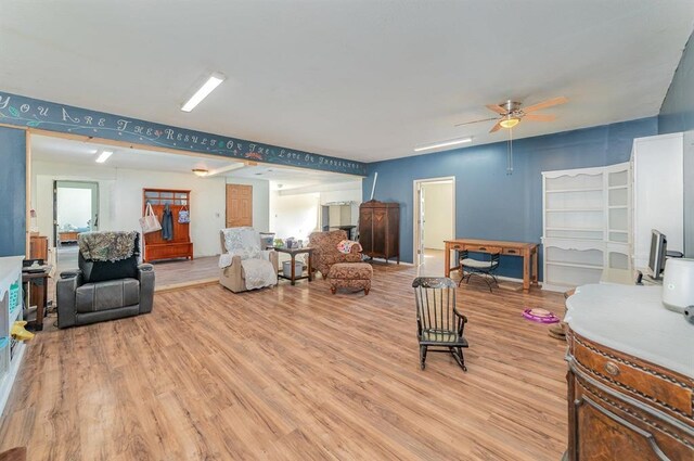 living room featuring light wood-type flooring and ceiling fan