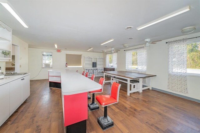 kitchen featuring ceiling fan, a center island, dark hardwood / wood-style floors, and white cabinetry