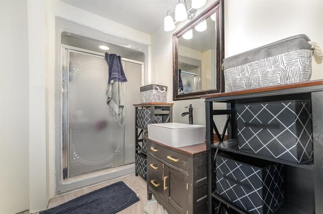 bathroom with vanity and a shower with door