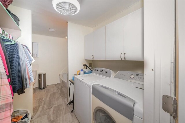 laundry room featuring cabinets and washer and dryer