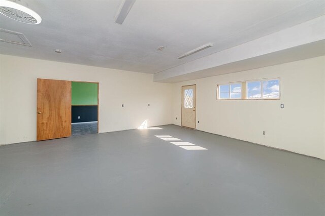 unfurnished room featuring concrete floors