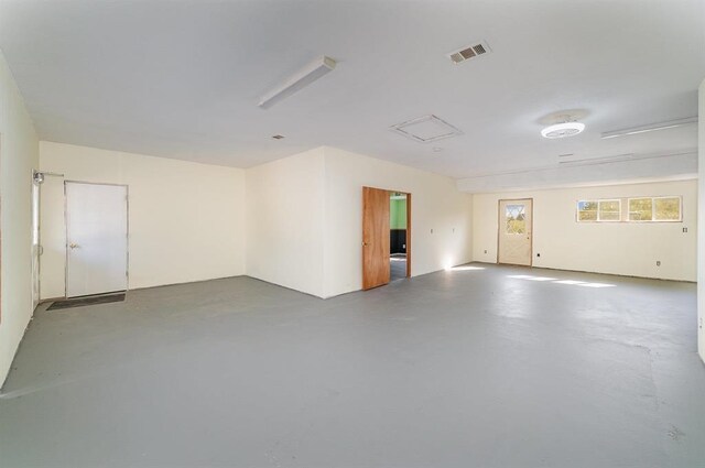 unfurnished room with concrete flooring