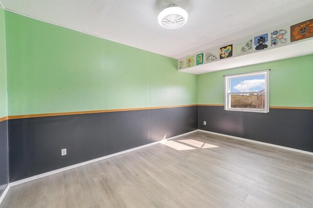 empty room with light hardwood / wood-style flooring