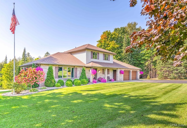 view of front of property with a front yard and a garage