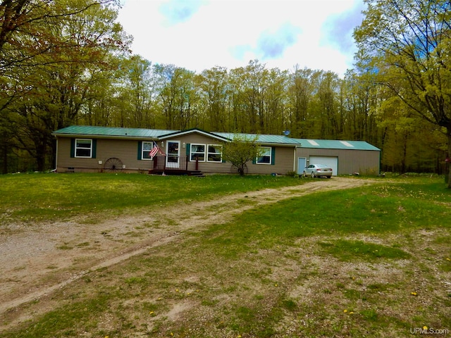 view of front of house with an outdoor structure, a garage, and a front yard