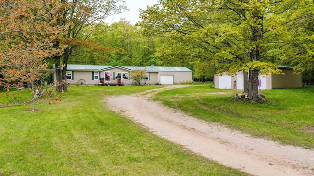 view of front facade with an outbuilding and a front lawn