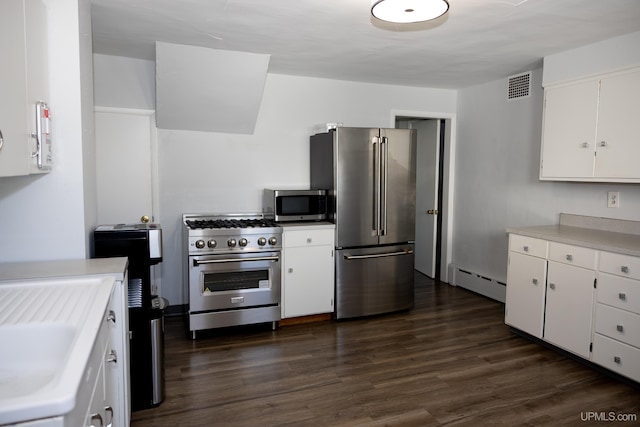 kitchen with a baseboard heating unit, white cabinets, appliances with stainless steel finishes, and dark hardwood / wood-style floors