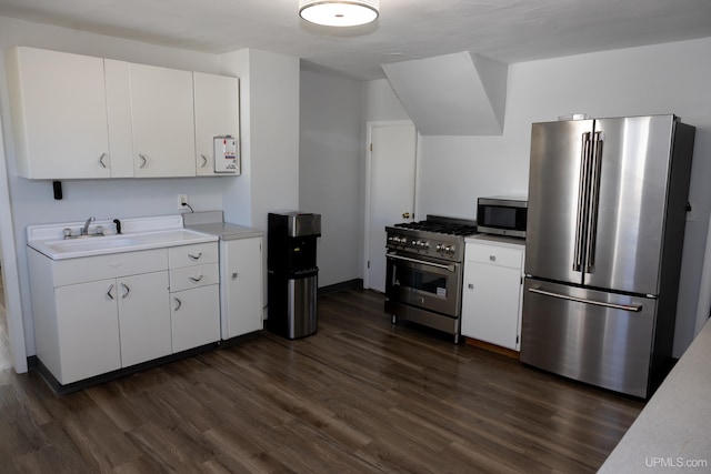 kitchen with white cabinets, sink, stainless steel appliances, and dark hardwood / wood-style flooring