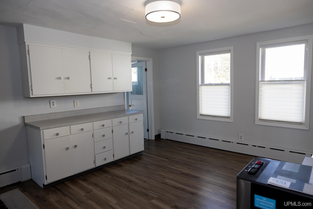 kitchen with a baseboard radiator, white cabinets, and dark wood-type flooring