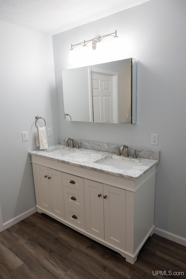 bathroom featuring hardwood / wood-style flooring and vanity