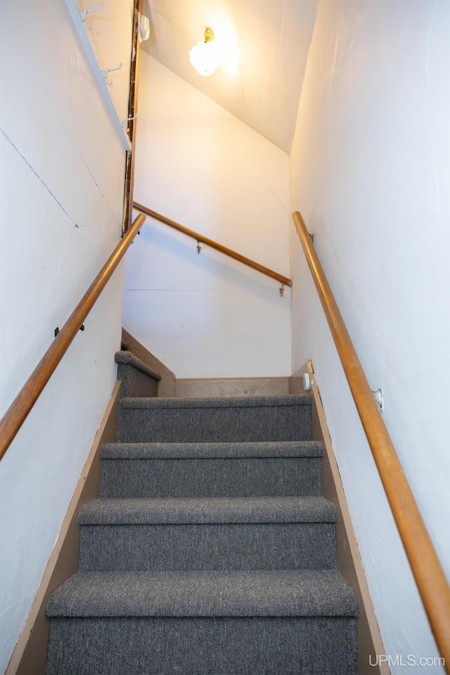 stairway featuring lofted ceiling