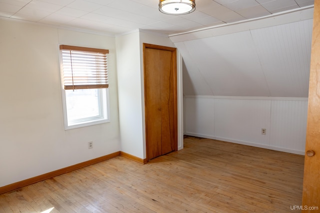 bonus room featuring vaulted ceiling and light hardwood / wood-style flooring