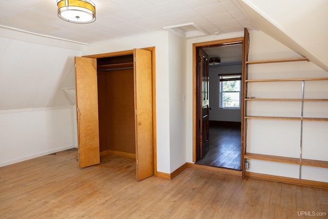 bonus room featuring light hardwood / wood-style floors and vaulted ceiling