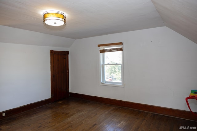 bonus room featuring lofted ceiling and dark hardwood / wood-style flooring