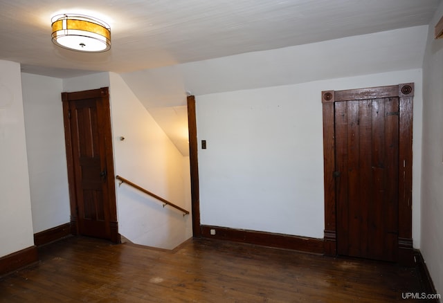 spare room featuring dark wood-type flooring