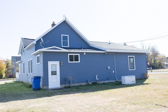 rear view of house with a yard