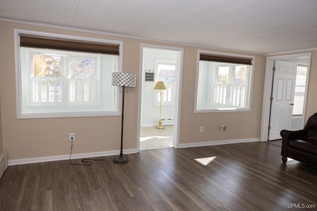 interior space with crown molding and dark hardwood / wood-style flooring