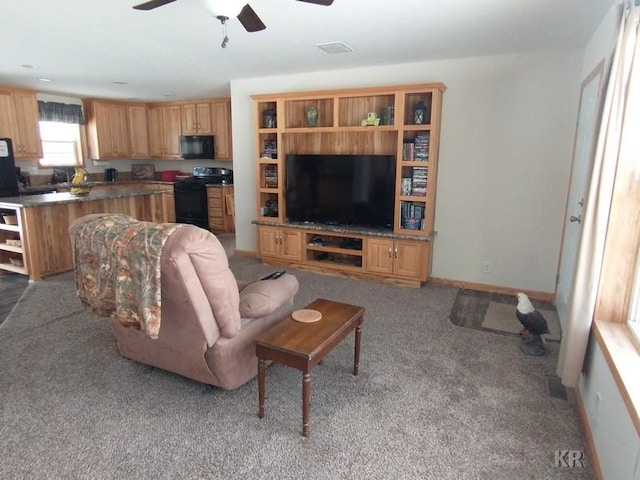 living room featuring ceiling fan and light colored carpet