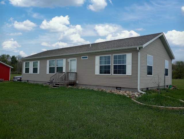 rear view of house with a lawn