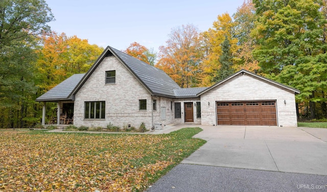 view of front facade with a front yard and a garage