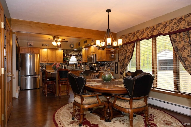 dining space featuring ceiling fan with notable chandelier, baseboard heating, and dark wood-type flooring