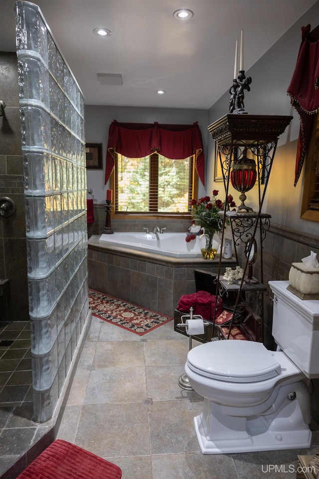 bathroom featuring separate shower and tub and toilet