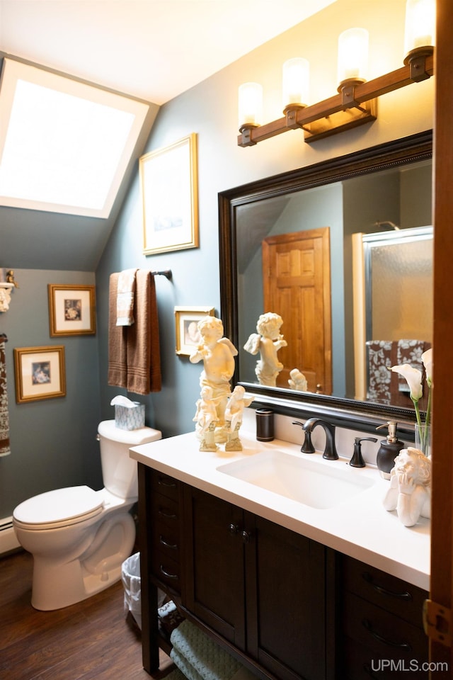 bathroom with vanity, toilet, wood-type flooring, vaulted ceiling, and a shower with door