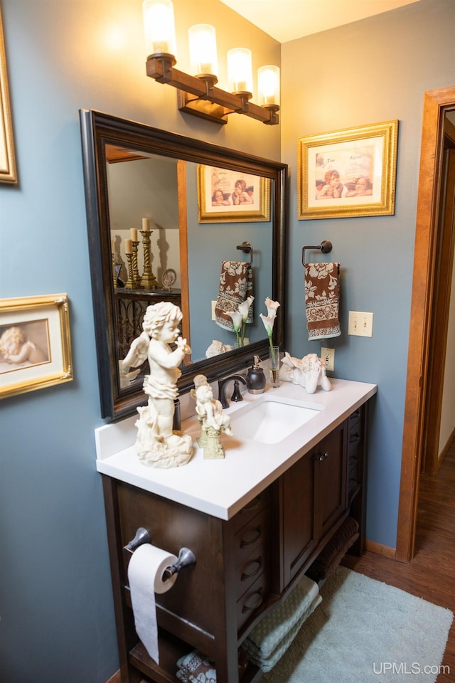 bathroom featuring hardwood / wood-style flooring and vanity