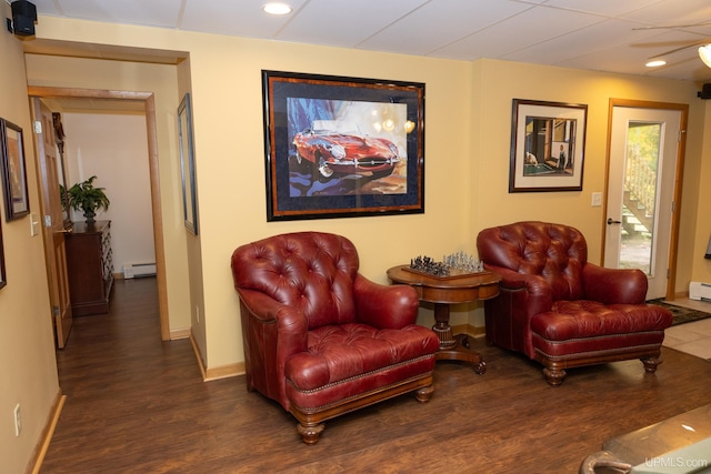 sitting room with dark hardwood / wood-style flooring and a baseboard radiator