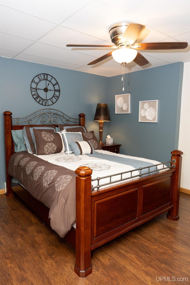 bedroom with dark hardwood / wood-style flooring and ceiling fan