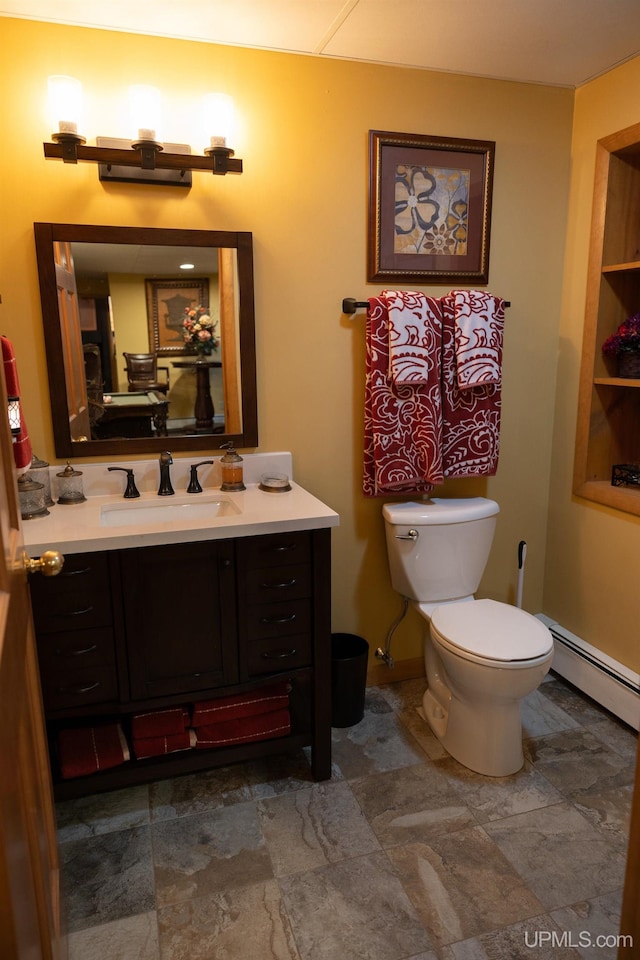 bathroom with vanity, toilet, and a baseboard radiator