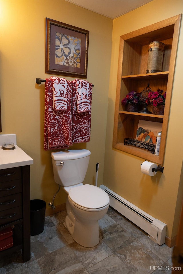 bathroom featuring vanity, toilet, and a baseboard heating unit