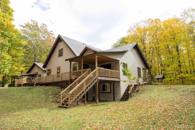 back of house with a deck and a yard