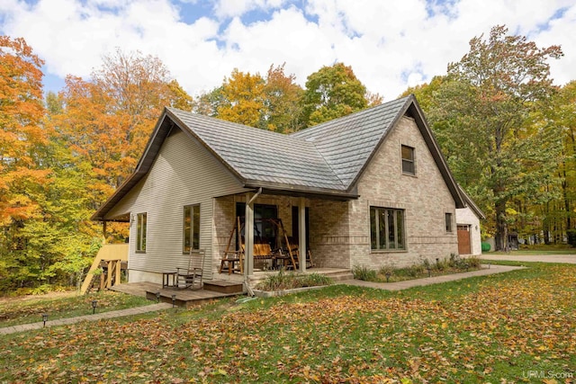 rear view of house featuring a porch