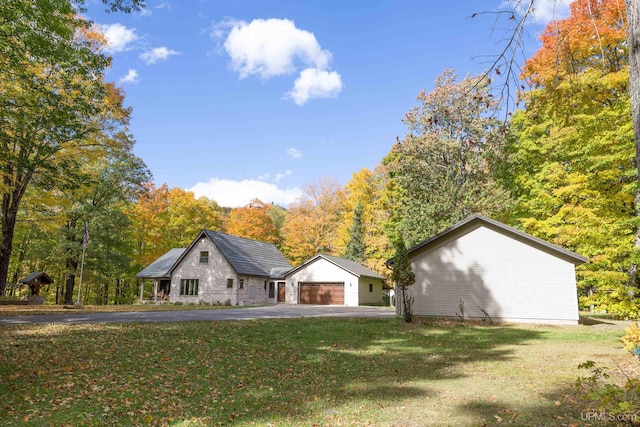 view of front of property featuring a garage and a front lawn